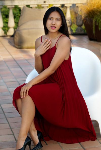 Photo №1 Asian teen May Thai reveals her shaved pussy under red dress